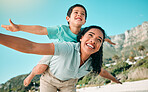 Mother, child and family outdoor at beach playing airplane game for fun. Happy woman and boy kid play and laughing for happiness, freedom and adventure on travel holiday or vacation with love outdoor