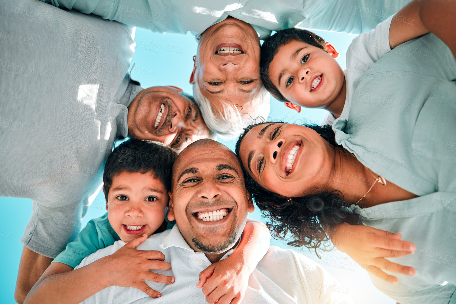 Buy stock photo Faces, love and portrait of a happy family smile feeling excited and bonding outdoors on holiday or vacation. Mother, father and grandparents with children or kids with happiness from below