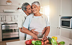 Cooking vegetables, hug and elderly couple with kitchen ingredients, prepare food or smile on romantic home date. Nutritionist, marriage love and hungry man, woman or people bonding over healthy meal