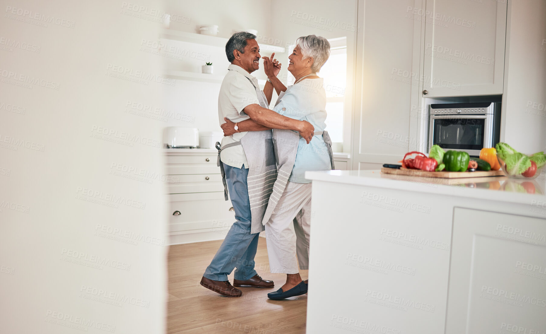 Buy stock photo Happy, cooking or elderly couple dance in the kitchen together and feeling love, excited and bonding in home. Care, happiness or romantic old people or lovers dancing and enjoying retirement in house