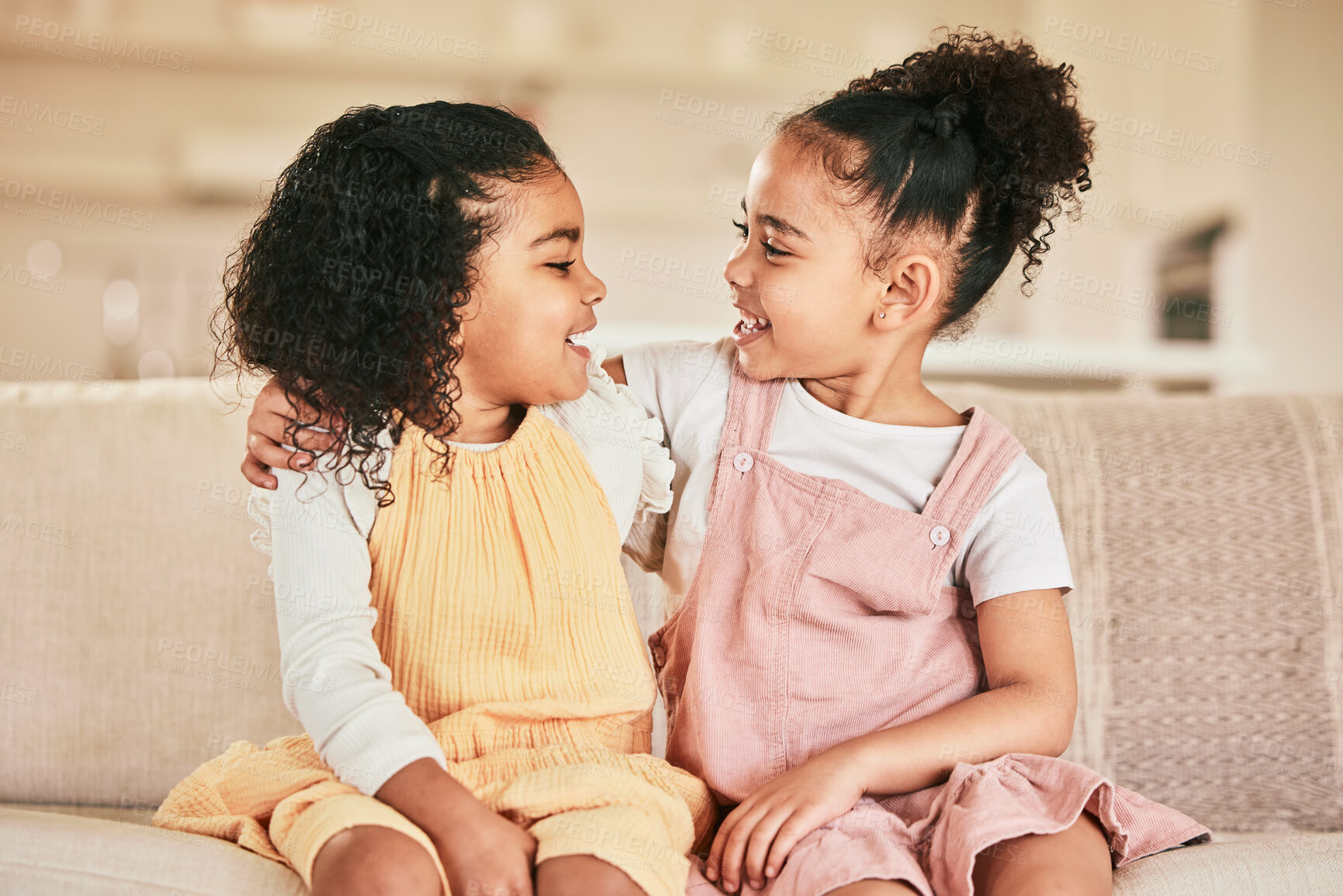 Buy stock photo Happy, children and sisters hugging on a sofa while bonding in the living room of their home. Happiness, friendship and girl kids embracing while talking and spending quality time together in a house