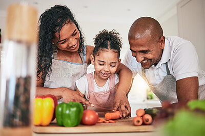 Buy stock photo Family, cooking or cutting vegetables in kitchen or learning chef skill with happy parents or child together. Nutrition, healthy food or organic with people teaching and learn to cook in home bonding