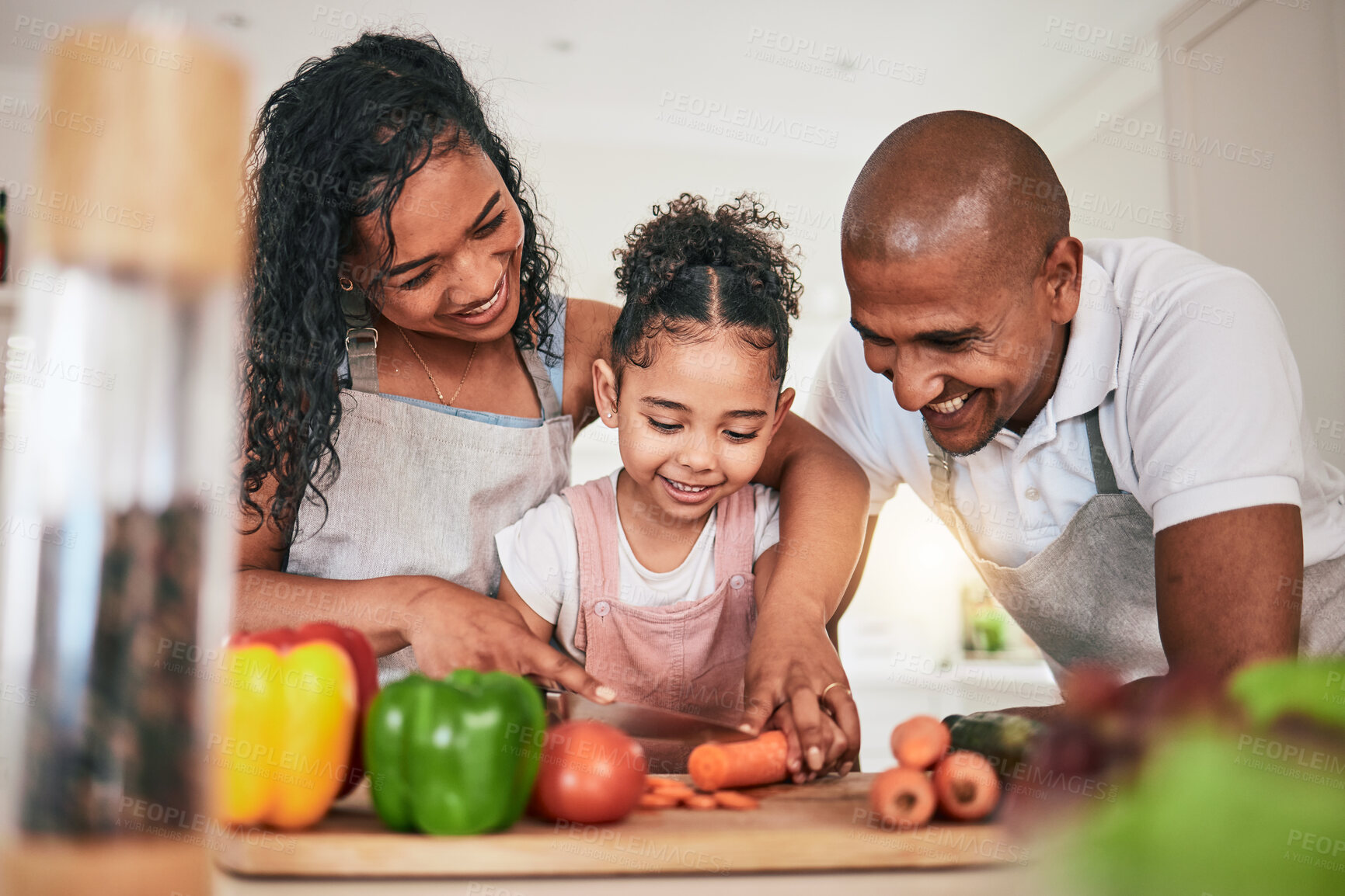 Buy stock photo Family, cooking or cutting vegetables in kitchen or learning chef skill with happy parents or child together. Nutrition, healthy food or organic with people teaching and learn to cook in home bonding