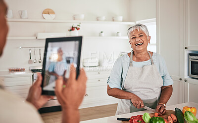 Buy stock photo Cooking food, elderly couple and tablet photo of senior woman, wife or person with digital memory picture. Vegetables nutritionist, photography shooting and laughing people bonding in health kitchen