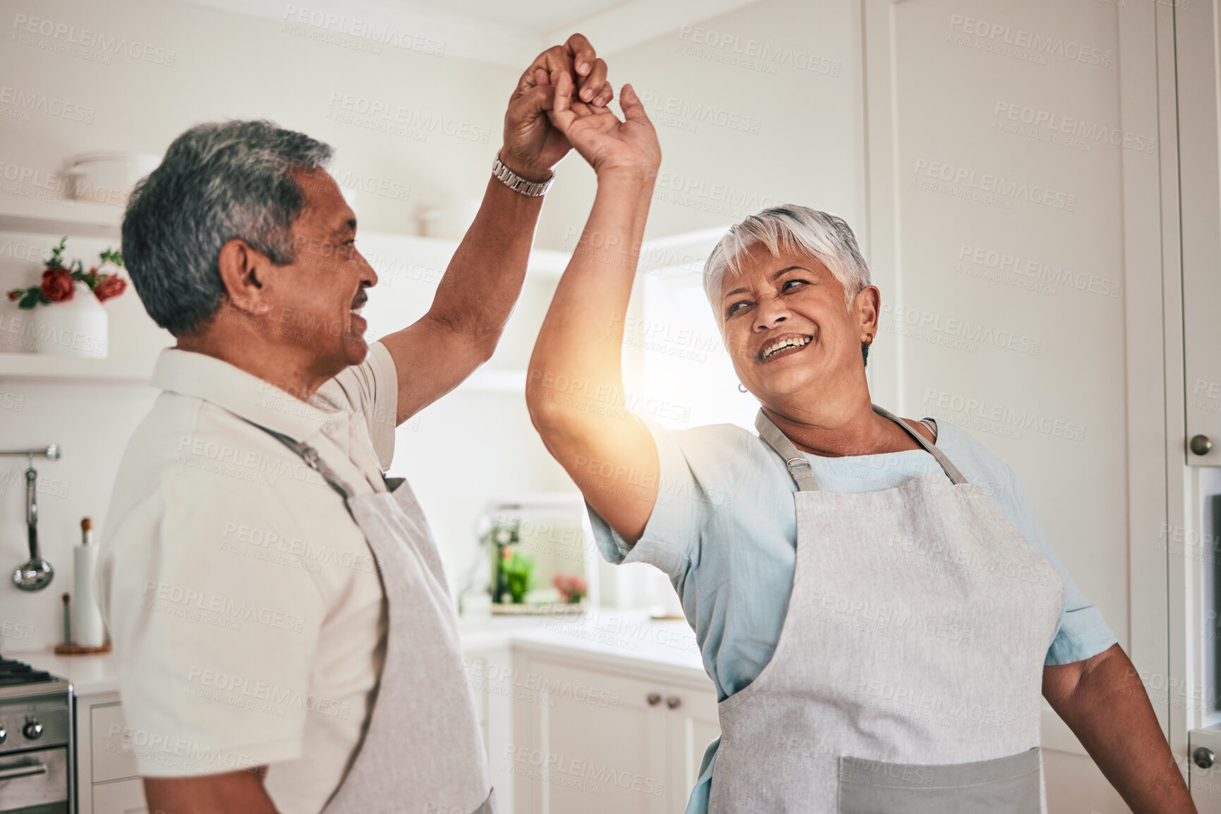 Buy stock photo Happy, cooking and senior couple dancing in the kitchen together and feeling love, excited and bonding in home. Care, happiness and romantic old people or lovers enjoying dance in a retirement house