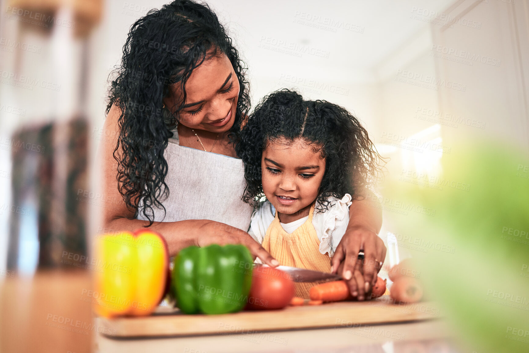 Buy stock photo Family, mother and kid cutting vegetables, cooking together and learning chef skill n kitchen. Nutrition, healthy food and organic with woman teaching girl and learn to cook at home with bonding