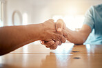 Handshake, table and hands of people for agreement, thank you and deal for support, unity and partnership. Community, collaboration and closeup of men shaking hand for friendship, trust and care