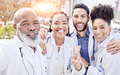 Buy stock photo Selfie, peace and collaboration with a team of doctors posing outdoor together while working at a hospital. Profile picture, healthcare and medical with a group of friends taking a photograph outside