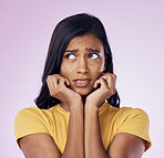 Scared, worry and face of Indian woman on pink background with fear, nervous and confused expression. Stress, anxiety mockup and isolated female with worried, anxious and crisis reaction in studio