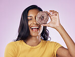 Donut, laughing and cover with woman in studio for diet, snack and happiness. Sugar, food and smile with female hiding and isolated on pink background for nutrition, playful and craving mockup