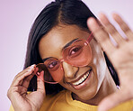 Heart, sunglasses and indian woman selfie in studio happy, cheerful and fun on purple background. Glasses, portrait and female gen z fashion influencer smile for profile picture, photo or blog post