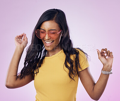 Buy stock photo Dancing, sunglasses and cool woman excited, happy and confident isolated in a pink studio background with joy. Singing, music and young genz female dance in celebration of a party energy with glasses