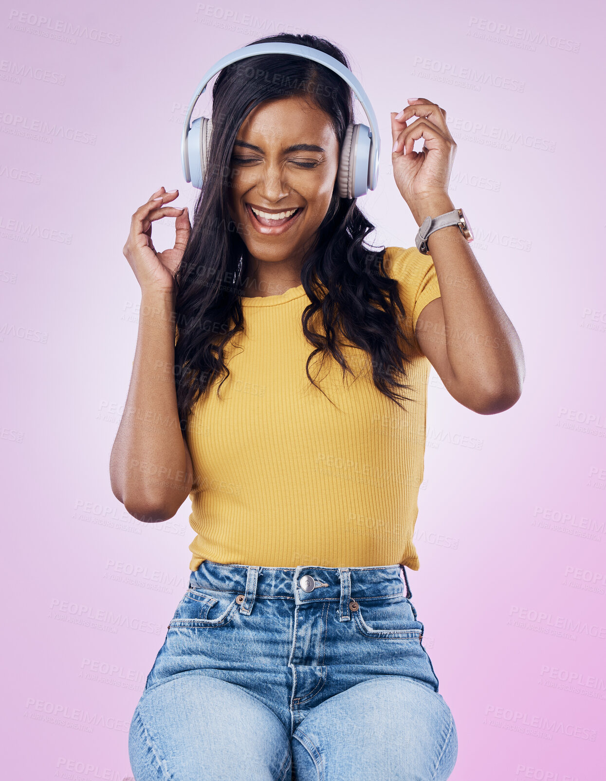 Buy stock photo Music, headphones and excited Indian woman dance on pink background listening to track, audio and radio. Relax, happy and isolated girl streaming song for dancing, chilling and happiness in studio