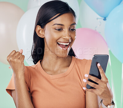 Buy stock photo Winner, phone and happy woman with party balloons for birthday celebration, prize or online giveaway success or news. Yes, fist pump and wow of indian person bonus, lotto or winning deal in studio