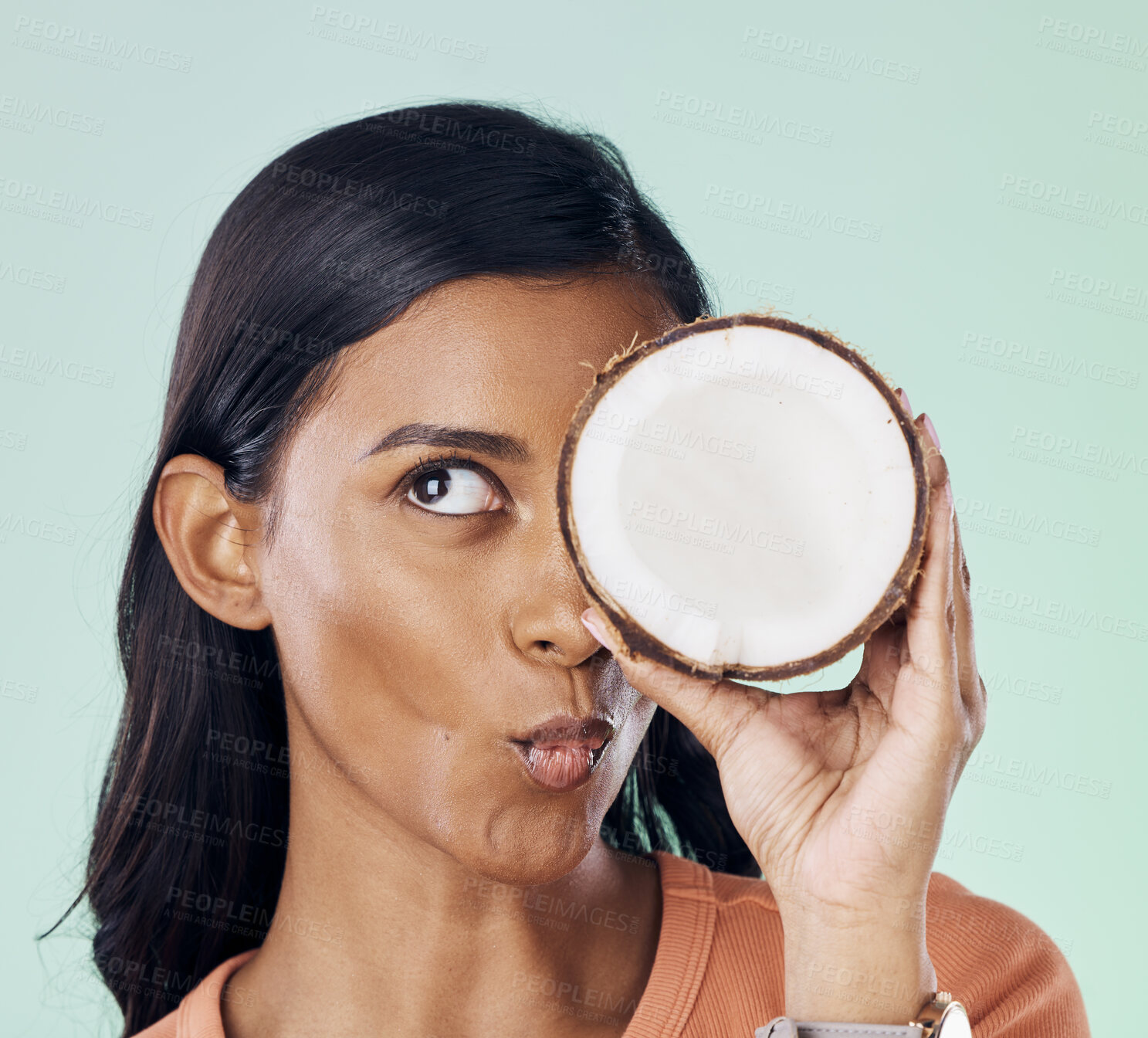 Buy stock photo Beauty, face or wellness woman with coconut for natural skincare glow, organic cosmetics or eco friendly makeup. Pucker, fruit nutrition benefits or person with clean healthy food on green background