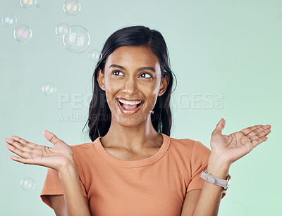 Buy stock photo Happy, bubbles and wow with woman in studio for creative, magic and rainbow. Playful, funny and laughing with female and excited and isolated on background for bright, happiness and freedom