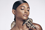 Fashion, studio and woman in with snake on neck for art aesthetic with exotic zoo animal on white background. Face, danger and creative style, asian beauty model with seductive look and dangerous pet