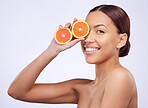 Skincare, orange and woman portrait in studio for vitamin c, treatment and cosmetics on purple background. Face, fruit and girl model relax with diy facial, organic or skin detox with citrus cleaning