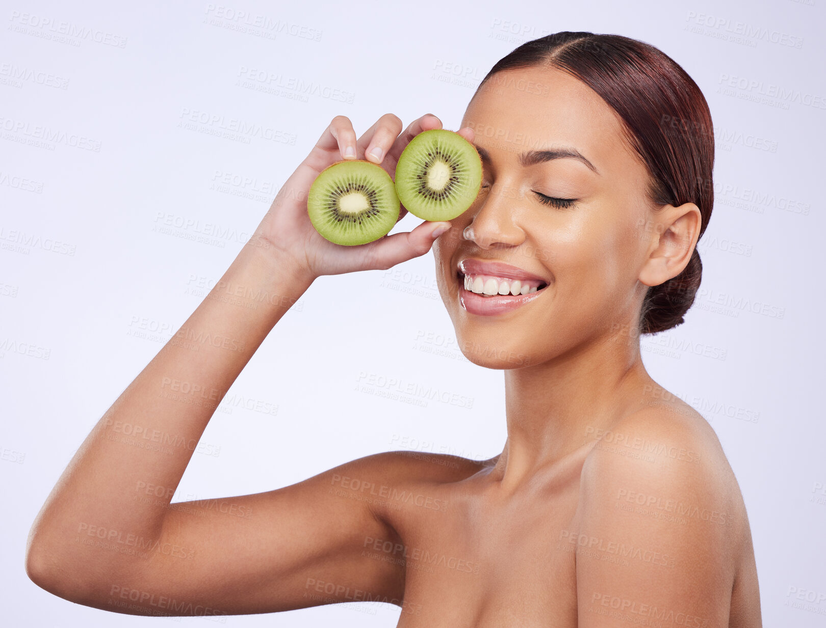 Buy stock photo Happy, skincare and kiwi with woman in studio for natural cosmetics, diet and nutrition. Product, glow and self care with female model and fruit on white background for spa, food and vitamin