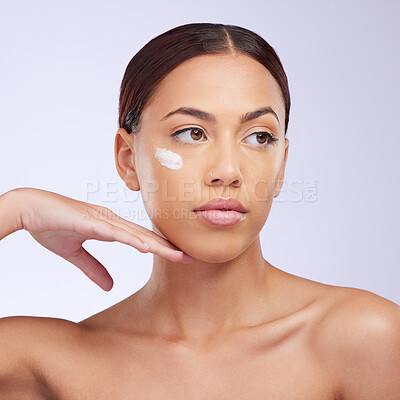 Buy stock photo Woman, skincare cream and thinking in studio for self care, aesthetic or beauty with product application on face. Girl, model and facial skin wellness with cosmetic, health or dermatology by backdrop