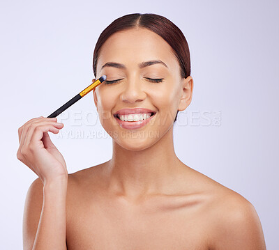 Buy stock photo Makeup, skincare or happy woman with eye pencil cosmetics facial beauty or wellness routine in studio. Smile, model or Brazilian girl applying foundation products or cosmetics with mockup space 