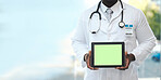 Hands, tablet and green screen with doctor in hospital for promotion, mockup space and branding. Black man, medic and mobile touchscreen for telehealth mock up, app or logo in clinic for healthcare