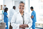 Senior doctor, woman and smile in clinic portrait for inspection, excited and vision for expert. Female medic, leadership and management with confidence, success and happy for career goal at hospital