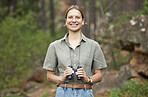 Binocular, forest and portrait of happy woman hiking for nature journey, jungle adventure and travel or outdoor explore. Face of a young person birdwatching and trekking in eco friendly, green woods