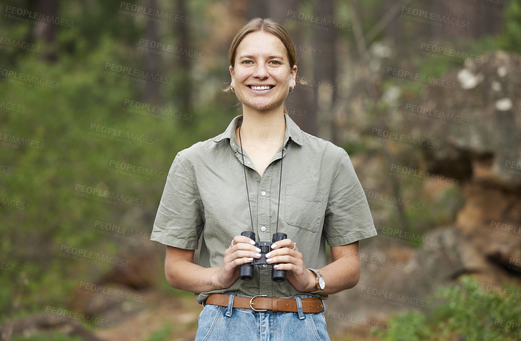Buy stock photo Binocular, forest and portrait of happy woman hiking for nature journey, jungle adventure and travel in outdoor explore. Face of a young person birdwatching and trekking in eco friendly green woods
