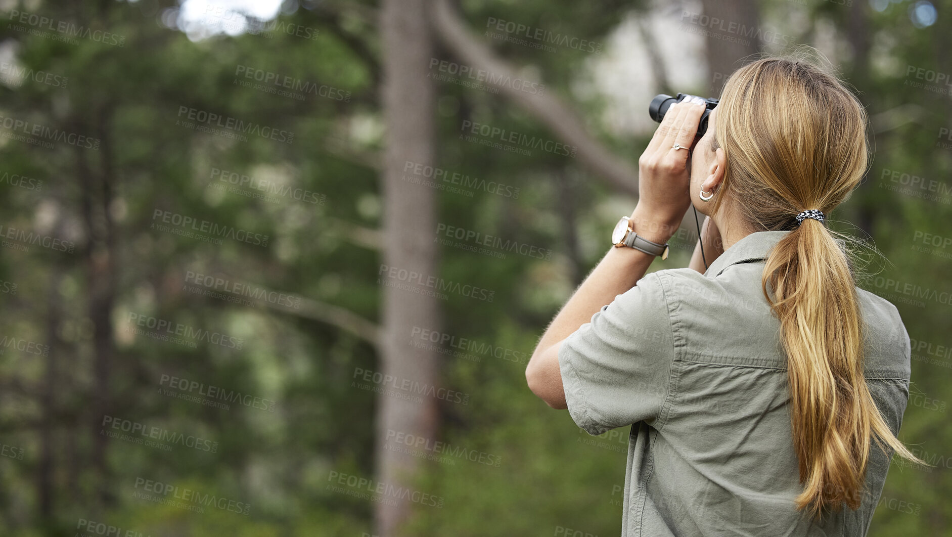 Buy stock photo Binoculars, forest and woman explore in nature, travel journey or outdoor adventure for carbon footprint research. Watch, search and back person birdwatching in jungle, woods or eco green environment