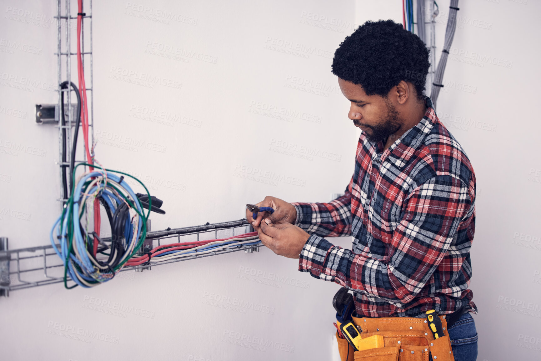Buy stock photo Technician, black man and electrician checking cables, fixing faulty wires and server mechanic. Male employee, entrepreneur and engineer with tools, electrical and maintenance with handyman and focus