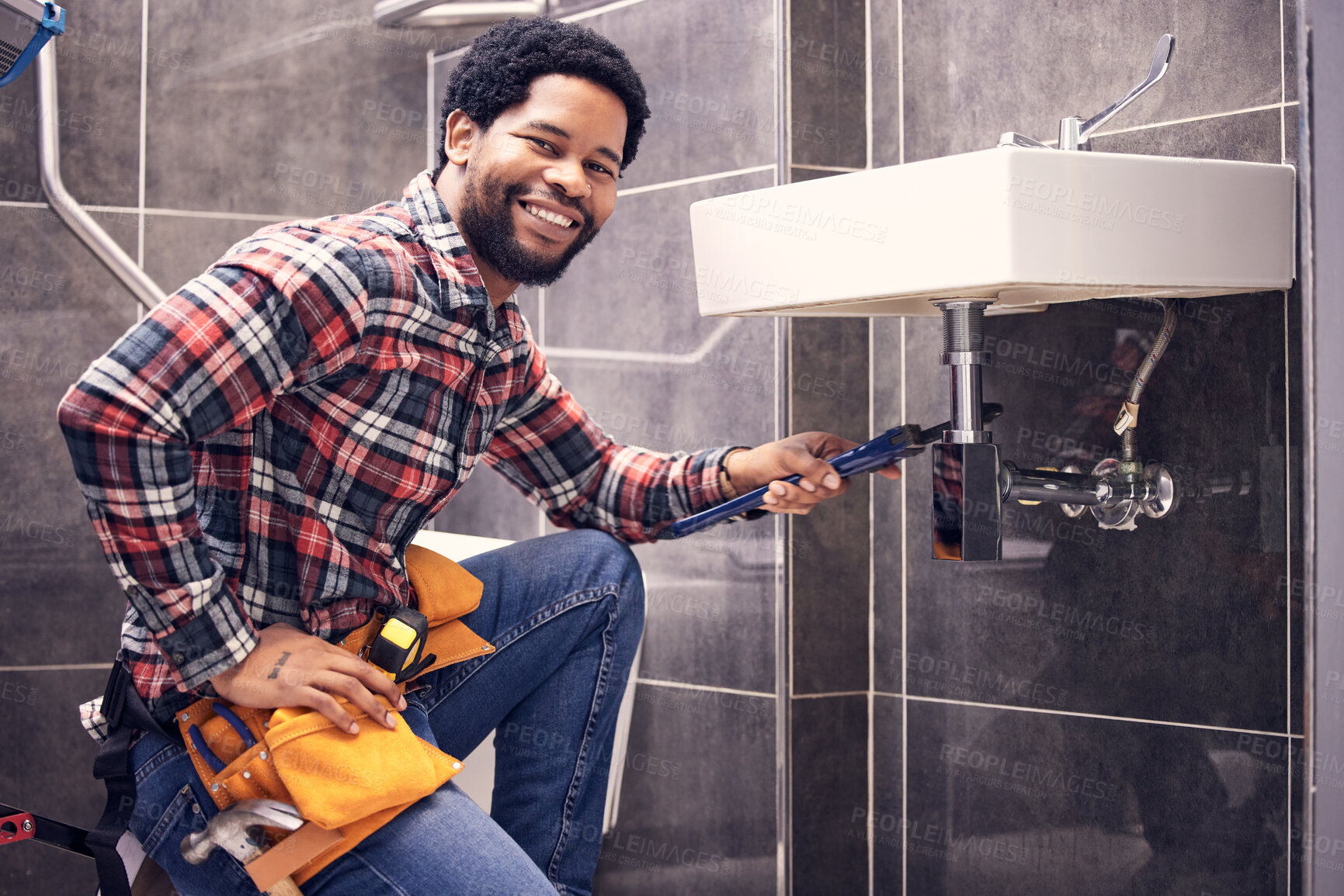 Buy stock photo Portrait, man and plumber with smile, maintenance and installation with home repairs. Face, Nigerian male employee or worker with tools, fixing pipes and sink with handyman, contractor and renovation