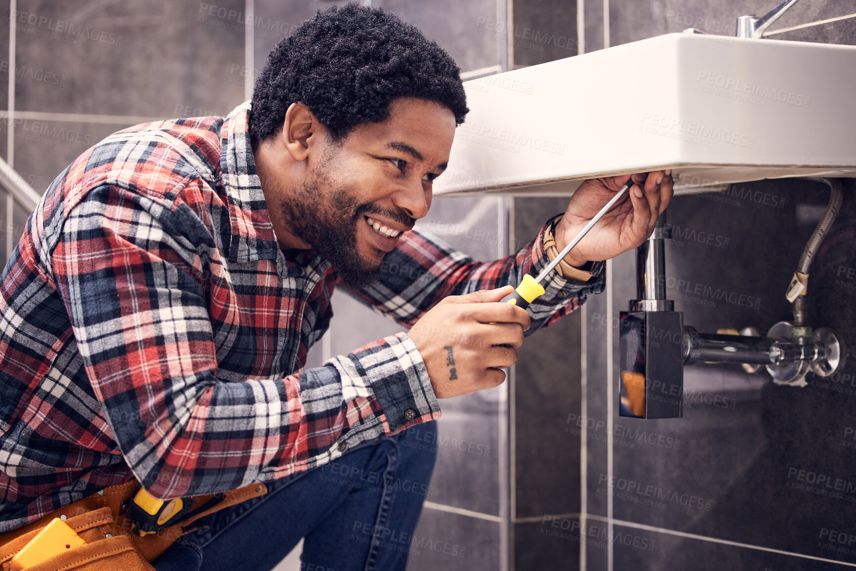 Buy stock photo Happy, man or plumber fixing a sink with smile in maintenance or installation in home repairs. African handyman or worker with plumbing tools to fix water pipes or house basin in renovation project 