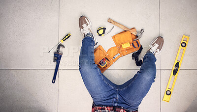 Buy stock photo Above, man and tools for construction on the floor, home maintenance or plumbing check. Building, service and a plumber in a house for renovation upgrade, handyman services and contractor project