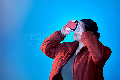 Buy stock photo Vr gaming or woman in metaverse studio for future innovation, cyber or 3d on blue background. Futuristic media mockup, technology software or girl gamer with digital virtual reality glasses online 