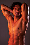 Man, sexy body and torso in studio for art, fitness or beauty of a person on a gray background. Face, strong muscle and male model with a six pack, glow and creative motivation for aesthetic backdrop