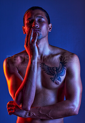 Sexy, beauty and man in dark light with chest tattoo as body art and model isolated in a studio background closed eyes. Creative, topless and young artistic person with seductive look in