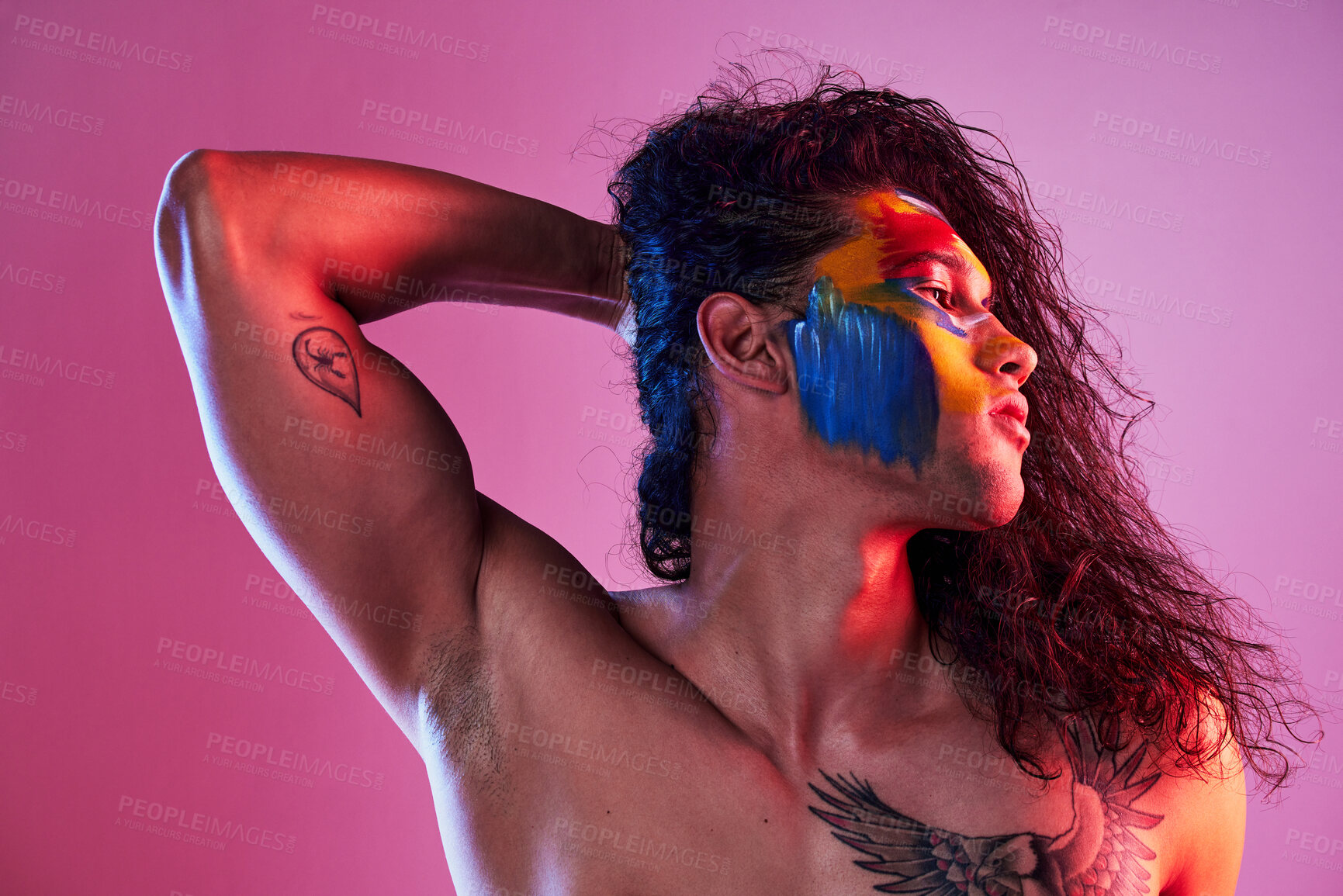 Buy stock photo Creative, face paint and art with man in studio for beauty, self love and designer. Fantasy, neon and light with male model and colors on pink background for makeup, abstract and cosmetics mockup