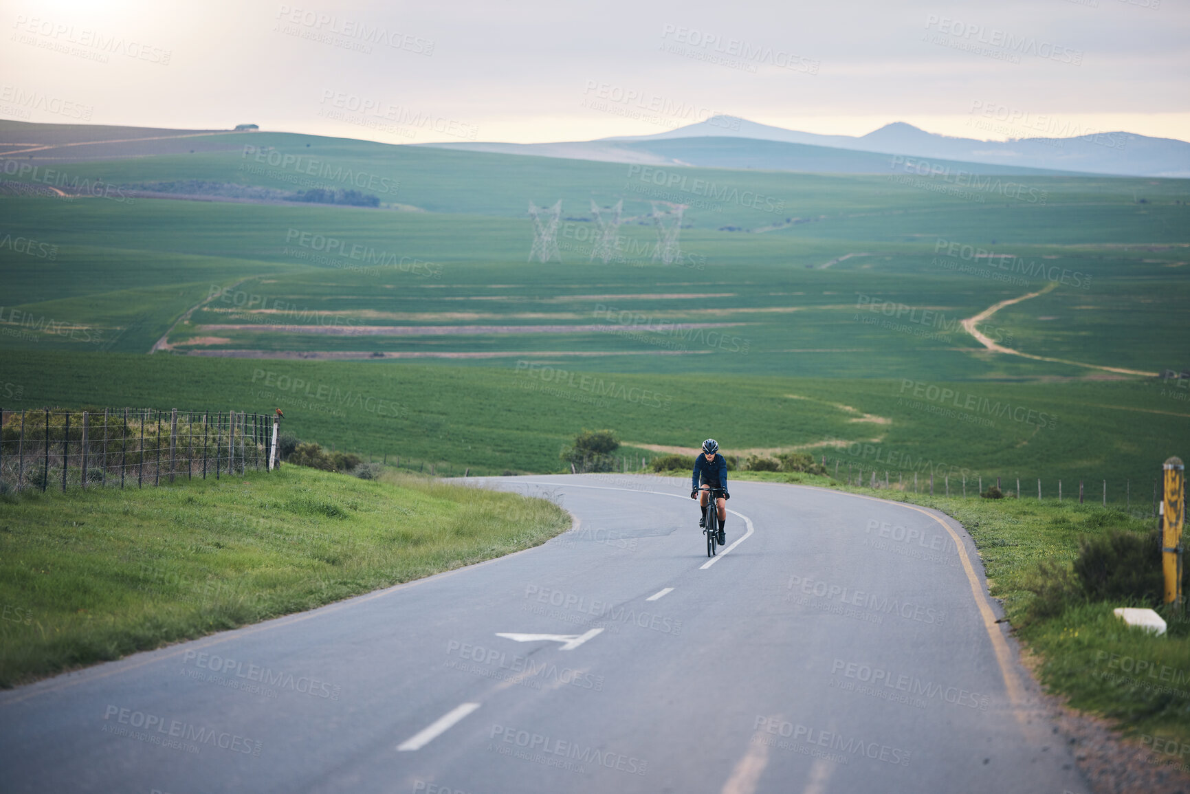 Buy stock photo Fitness, nature and cyclist cycling on a mountain while training for a race, competition or marathon. Sports, health and athlete doing a cardio exercise or workout with bicycle in the road on a hill.