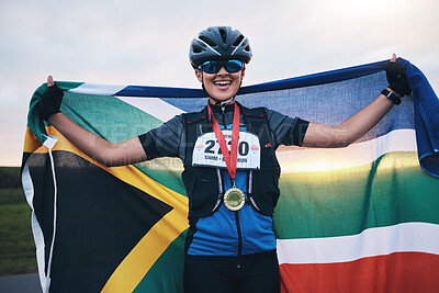 Buy stock photo Winner sports, happy woman from South Africa with flag and gold medal winning, outdoor cycling race or triathlon. Happiness, win and cyclist with smile, fitness and world record with national pride.
