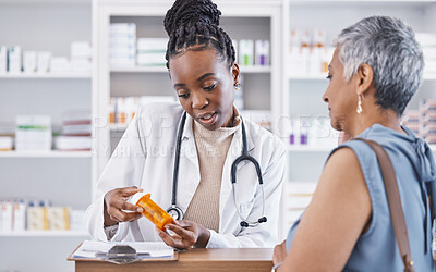 Buy stock photo Black woman, doctor and prescription medication for patient or over the counter pills at pharmacy. African medical pharmacist consulting senior client for dosage, symptoms or side effects at clinic