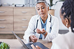 Doctor, laptop and woman consulting in Telehealth, healthcare prescription or medicare diagnosis at desk. Senior female medical expert in webinar, meeting or online consultation on computer at clinic