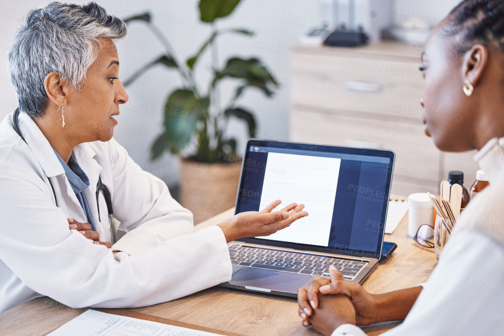 Buy stock photo Showing results, talking and a doctor with a black woman for notes, plan and strategy for health. Discussion, help and a mature female gp speaking to an African patient about medical progress