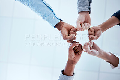 Buy stock photo Business people, fist circle and teamwork in low angle, team building and trust in office. Solidarity, huddle and group or staff of men and women with hands together for unity, synergy or cooperation