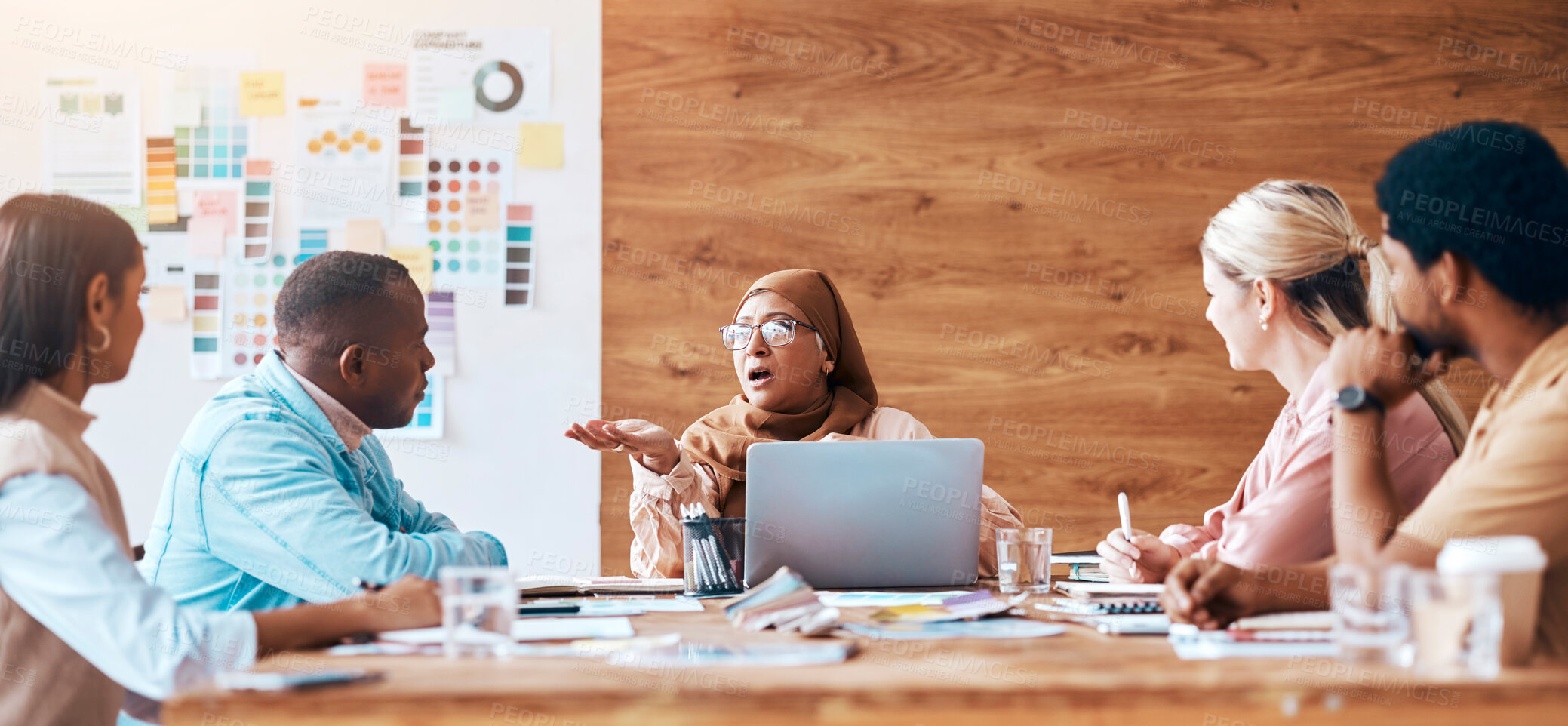 Buy stock photo Meeting, collaboration and training with a woman manager talking to her team in the boardroom for planning. Teamwork, strategy and development with a mature muslim employee coaching her staff at work