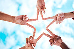 People, hands and peace sign in collaboration, trust or unity in partnership or community star formation with sky below. Diverse group touching hands for teamwork, success or motivation in solidarity
