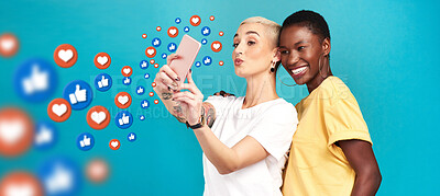 Buy stock photo Diversity, social media icons or women take a selfie for content or online post on blue background. Love emojis, friends or happy girls take fun pictures together on mobile app or network in studio