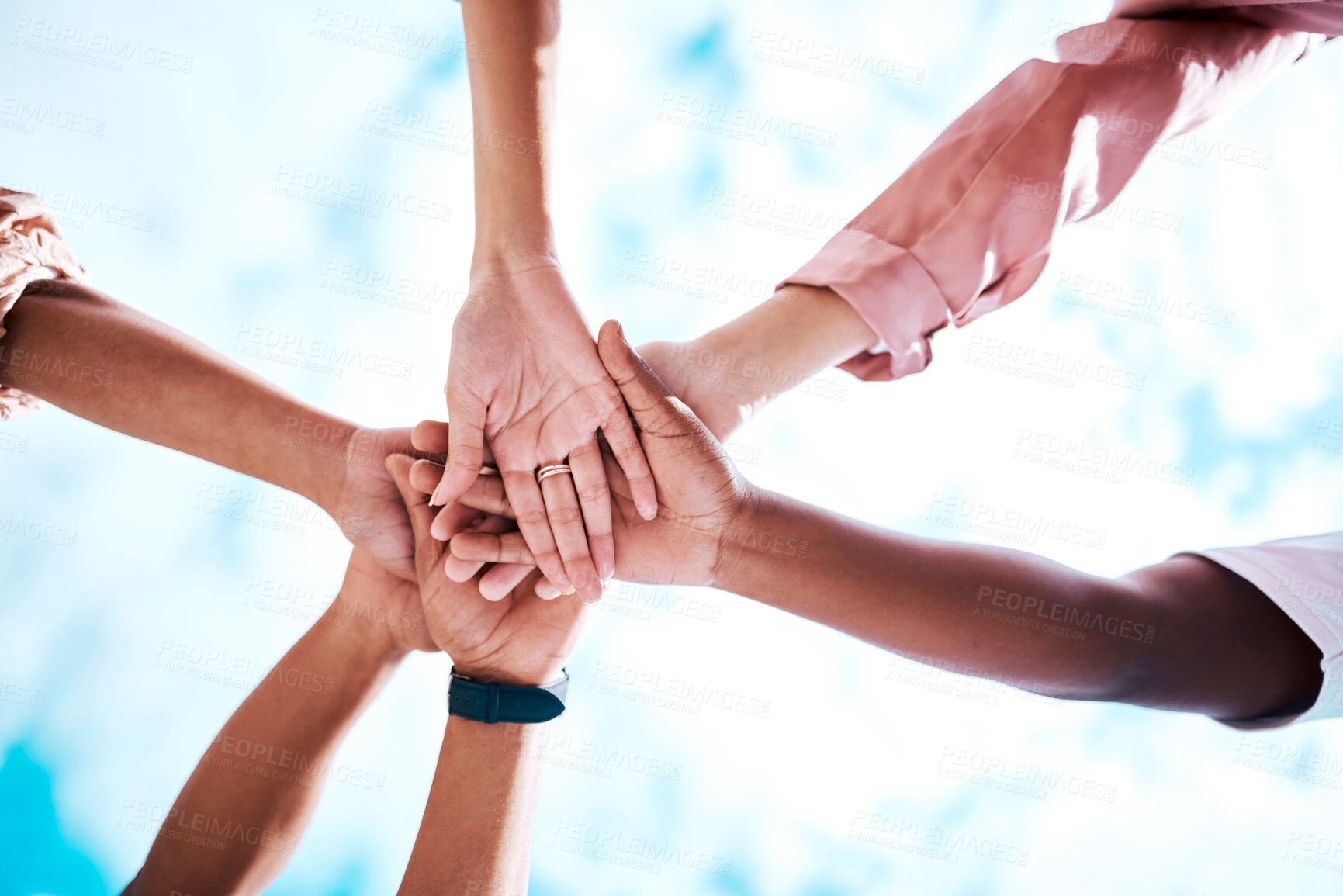 Buy stock photo Hands stacked, motivation and team building on a blue sky for trust, community and about us. Mission, support and friends in a low huddle for success, celebration and solidarity  together as a group