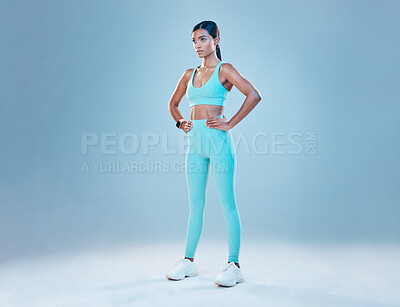 Buy stock photo Exercise, focus and mockup with a sports woman in studio on a blue background for health or wellness. Fitness, mindset and space with a young female athlete training for a healthy body or lifestyle