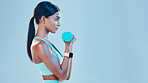 Sports, workout and female with weights in studio for arm or strength training with motivation. Fitness, exercise and Indian woman athlete with dumbells isolated by blue background with mockup space.